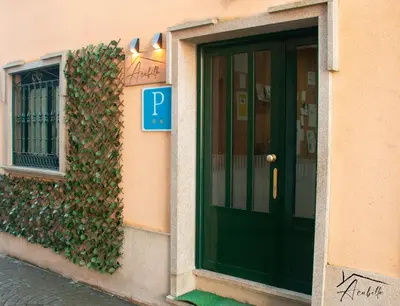 a building with a green door and a window at ACUBILLO in Palas de Rei
