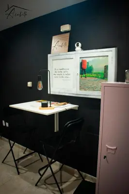 a white table in a room with a black wall at ACUBILLO in Palas de Rei