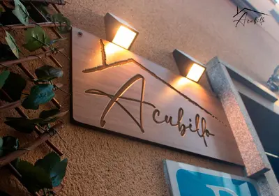 a sign for a club with lights on a wall at ACUBILLO in Palas de Rei