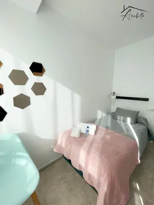 a bedroom with a bed and a chair in it at ACUBILLO in Palas de Rei