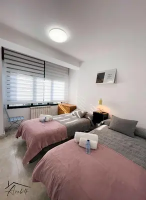 a room with three beds and a window at ACUBILLO in Palas de Rei
