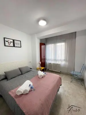 a bedroom with a bed with two animal towels on it at ACUBILLO in Palas de Rei