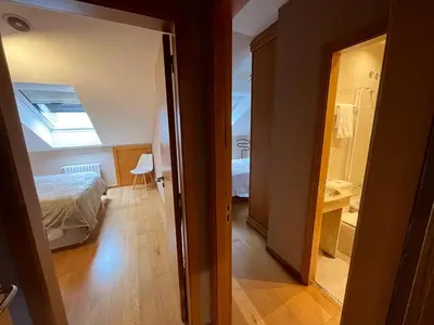 a bedroom with a bed and a room with a bathroom at Paz Termal in Ourense