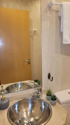 a bathroom with a stainless steel sink and a mirror at Paz Termal in Ourense