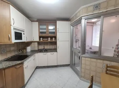 a kitchen with white cabinets and a sink at Ares-Mar in Ares