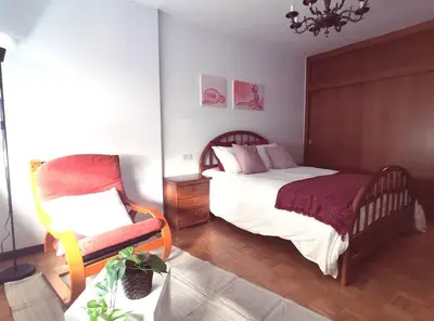 a bedroom with a bed and a chair in it at Ares-Mar in Ares