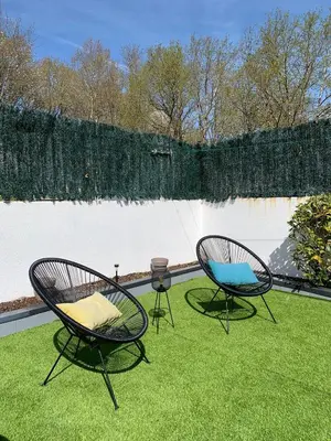 two chairs sitting on the grass in a yard at Fogar de Aurora in Portomarin