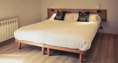 a large white bed with pillows on top of it at O Lagoeiro in A Estrada