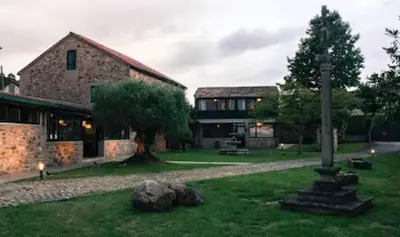 a building with a pole in the middle of a yard at O Lagoeiro in A Estrada