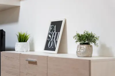 a dresser with two plants and a sign on it at FondeRiviere in Caldas de Reis
