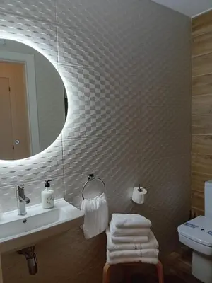 a bathroom with a sink and a mirror at PortoSantiago Boutique & Rooms in Portomarin
