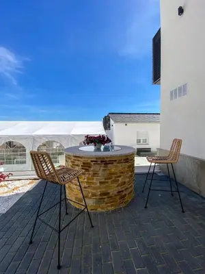 two chairs and a table on a patio at PortoSantiago Boutique & Rooms in Portomarin