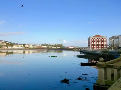 a large body of water with a bird flying over it at The Cliffs - Montmar in Viveiro