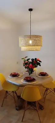 a dining room table with plates and flowers on it at Casa Vilas, Santiago de Compostela in Santiago de Compostela