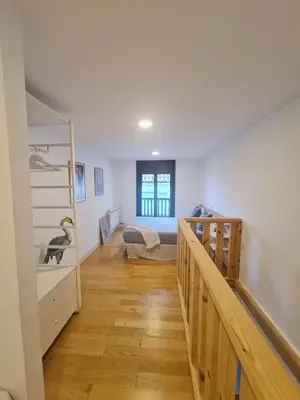 a hallway with a bedroom and a bed in a room at Casa típica Betanzos Casco Histórico in Betanzos