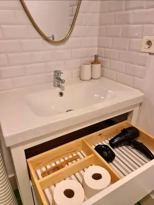 a bathroom with a sink and a counter with toilet paper at Casa típica Betanzos Casco Histórico in Betanzos