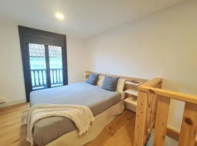 a bedroom with a bed and a window at Casa típica Betanzos Casco Histórico in Betanzos