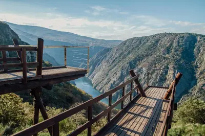 a viewing platform with a view of a river in the mountains at Casiñas do Sil in Cristosende