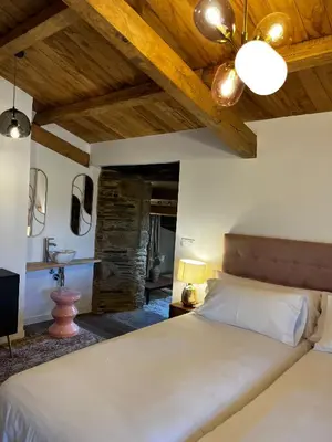 a bedroom with a large bed and a sink at Hotel Casas da Fortaleza in Lugo