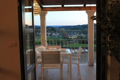 a dining room with a table and chairs on a balcony at Hotel Casas da Fortaleza in Lugo