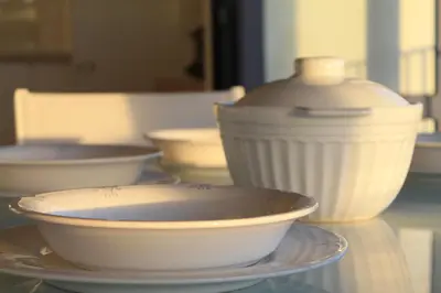 a group of bowls and plates on a glass table at Hotel Casas da Fortaleza in Lugo