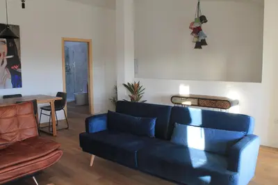 a living room with a blue couch and a table at Hotel Casas da Fortaleza in Lugo