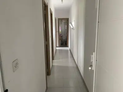 a hallway with white walls and a long white hallway at Viviendas uso turístico REME II in Foz