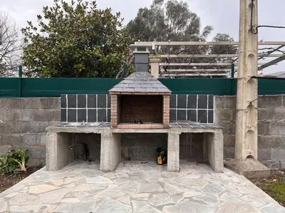 a brick oven sitting on top of a patio at Viviendas uso turístico REME II in Foz