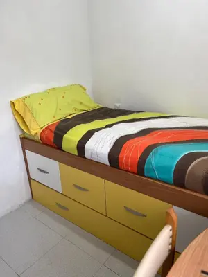 a bedroom with a bed with a colorful blanket on it at Viviendas uso turístico REME II in Foz