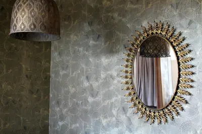 a mirror hanging on a wall with a curtain at HOTEL CASAS DA FORTALEZA Casa da Muralla in Outeiro de Rei