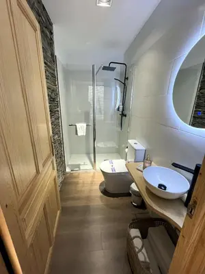 a bathroom with a toilet and a sink and a shower at HOTEL CASAS DA FORTALEZA Casa da Muralla in Outeiro de Rei