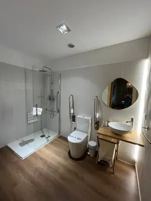 a bathroom with a toilet and a sink and a mirror at HOTEL CASAS DA FORTALEZA Casa da Muralla in Outeiro de Rei