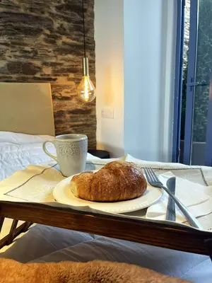 a plate of bread and a cup of coffee on a table at HOTEL CASAS DA FORTALEZA Casa da Muralla in Outeiro de Rei