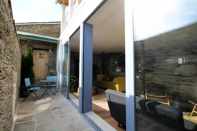 a glass extension to a house with a patio at HOTEL CASAS DA FORTALEZA Casa da Muralla in Outeiro de Rei