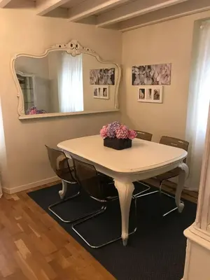 a dining room table with chairs and a mirror at VILLA OLIMAR in San Juan de Prendones