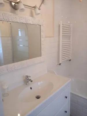 a bathroom with a sink and a mirror and a tub at VILLA OLIMAR in San Juan de Prendones