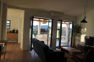 a living room with a couch and chairs and sliding glass doors at HOTEL CASAS DA FORTALEZA Casa da Solaina in Outeiro de Rei