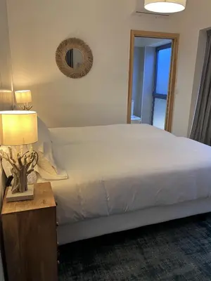 a bedroom with a bed and a table with a lamp at HOTEL CASAS DA FORTALEZA Casa da Solaina in Outeiro de Rei