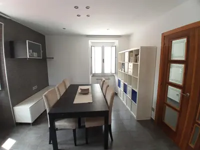 a dining room with a black table and chairs at Abrigadoiro de Rexa in Barreiros