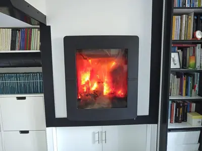 a fire in a fireplace in a book shelf at Abrigadoiro de Rexa in Barreiros