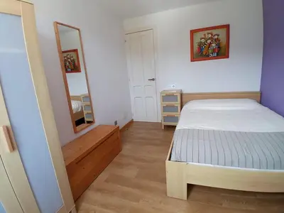 a small bedroom with a bed and a mirror at Abrigadoiro de Rexa in Barreiros