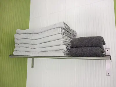 a pile of towels on a shelf in a bathroom at Abrigadoiro de Rexa in Barreiros