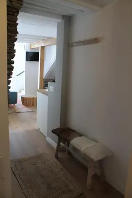 a room with a bench next to a wall at HOTEL CASAS DA FORTALEZA Casa do Garda in Outeiro de Rei