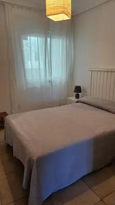 a bedroom with a large bed and a window at Apartamento Oceano in Barreiros
