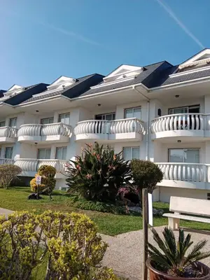 a large white building with solar panels on it at Apartamento Oceano in Barreiros