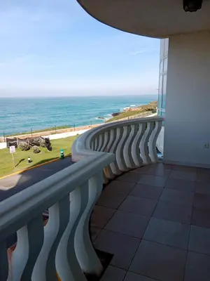 a view of the ocean from the balcony of a building at Apartamento Oceano in Barreiros