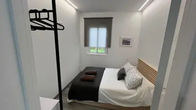 a small bedroom with a bed and a window at Jabego2 in Sarria