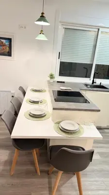 a kitchen with a table with chairs and a sink at Jabego2 in Sarria