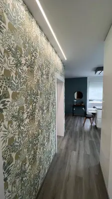 a living room with a wall with a floral wallpaper at Jabego2 in Sarria