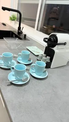 a counter with four blue cups and saucers on it at Jabego2 in Sarria